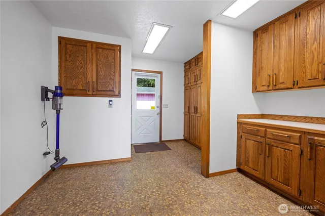 a view of a kitchen with cabinets and a refrigerator
