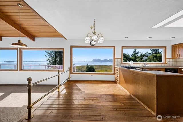 a view of a living room and kitchen with a large window