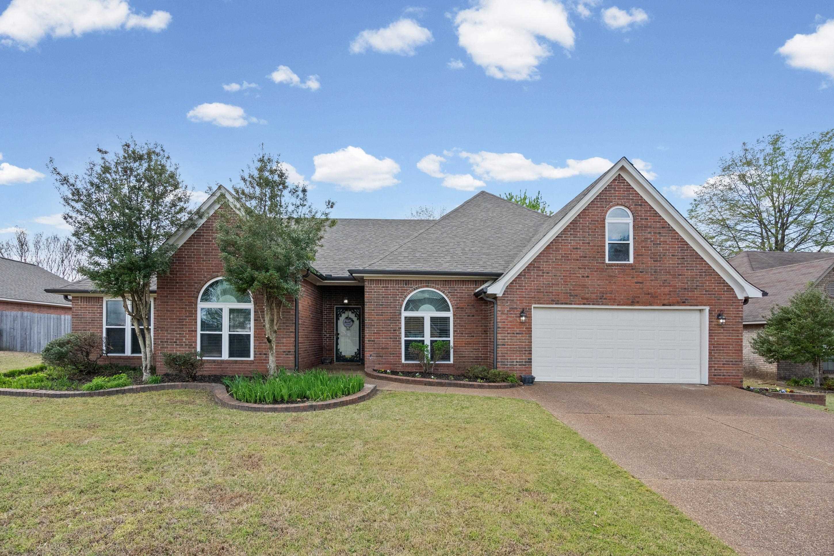 1301 Wolf Lair Drive Collierville, TN 38017 - Photo 1 of 32 View of front facade featuring roof with shingles, brick siding, concrete driveway, and a front yard