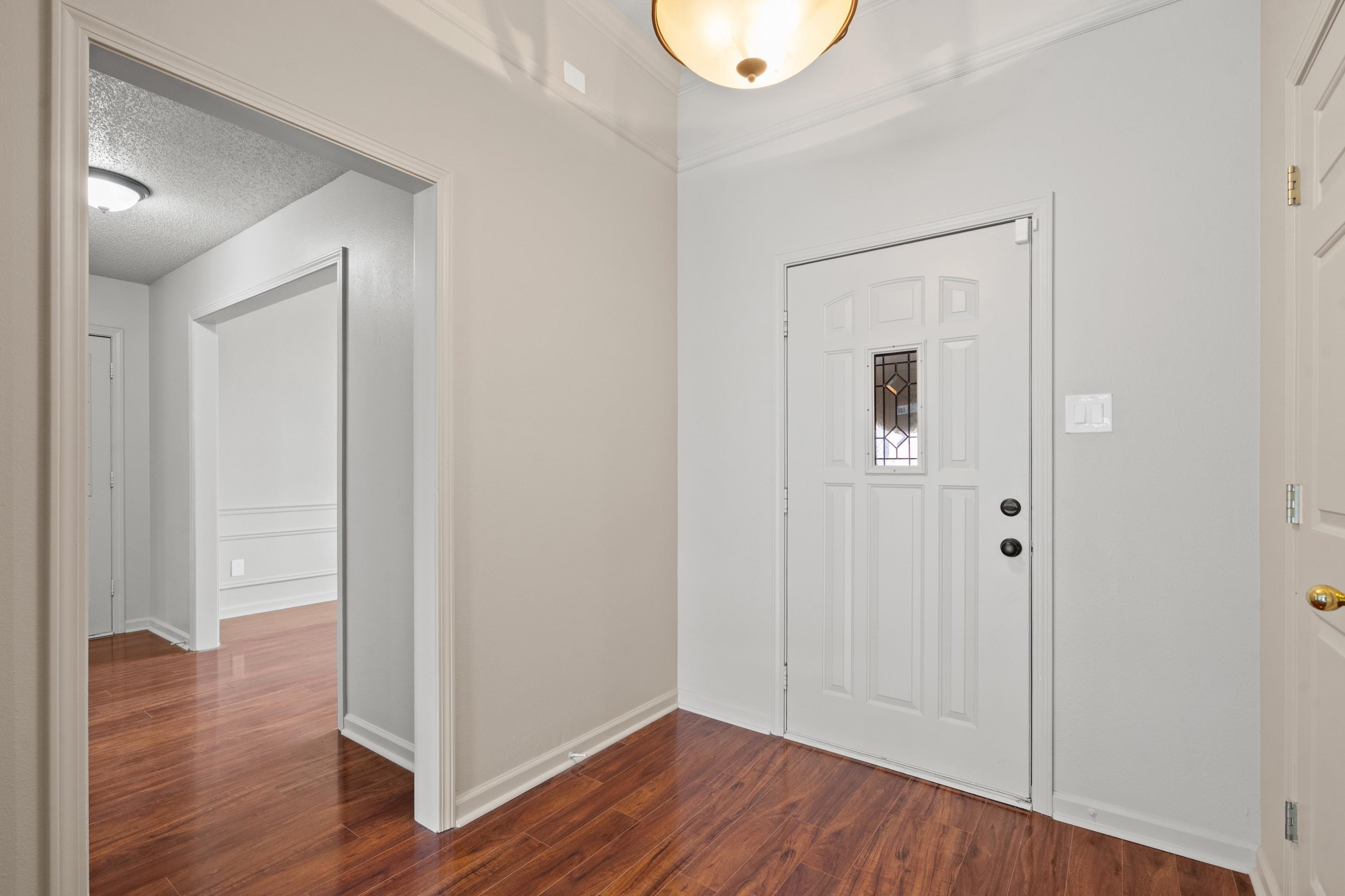 1301 Wolf Lair Drive Collierville, TN 38017 - Photo 13 of 32 Foyer entrance featuring dark wood finished floors and a textured ceiling