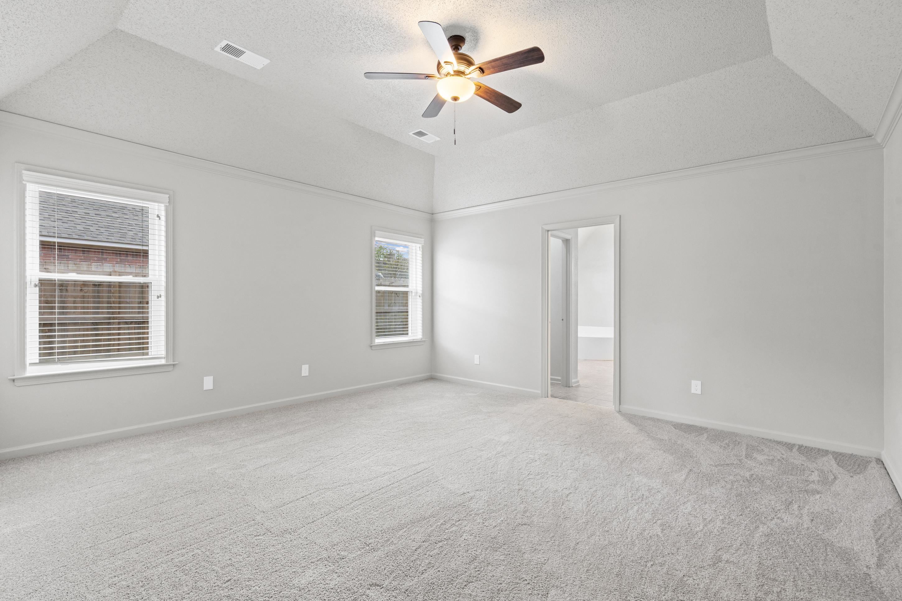 1301 Wolf Lair Drive Collierville, TN 38017 - Photo 14 of 32 Large Primary Bedroom with a ceiling fan and light carpet