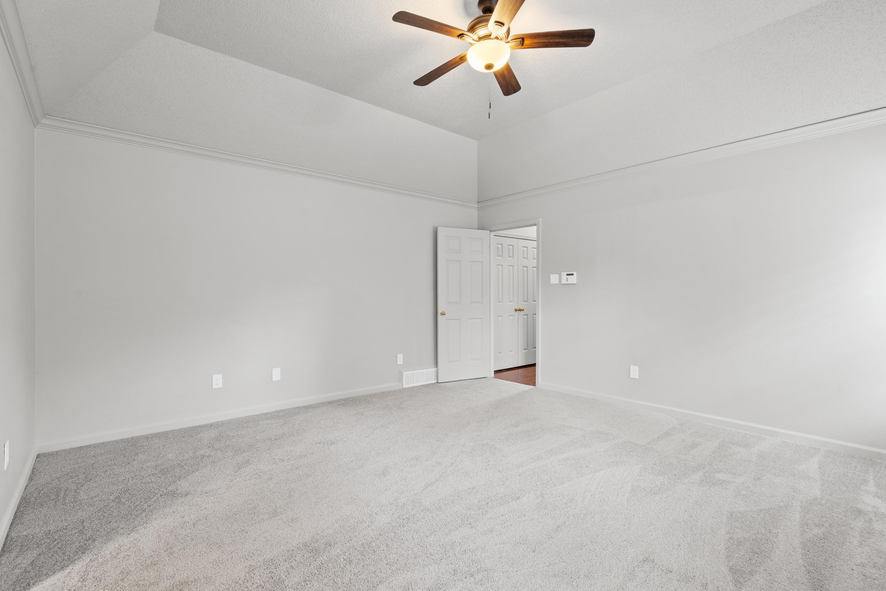 1301 Wolf Lair Drive Collierville, TN 38017 - Photo 15 of 32 Unfurnished room featuring light carpet, a ceiling fan, and lofted ceiling