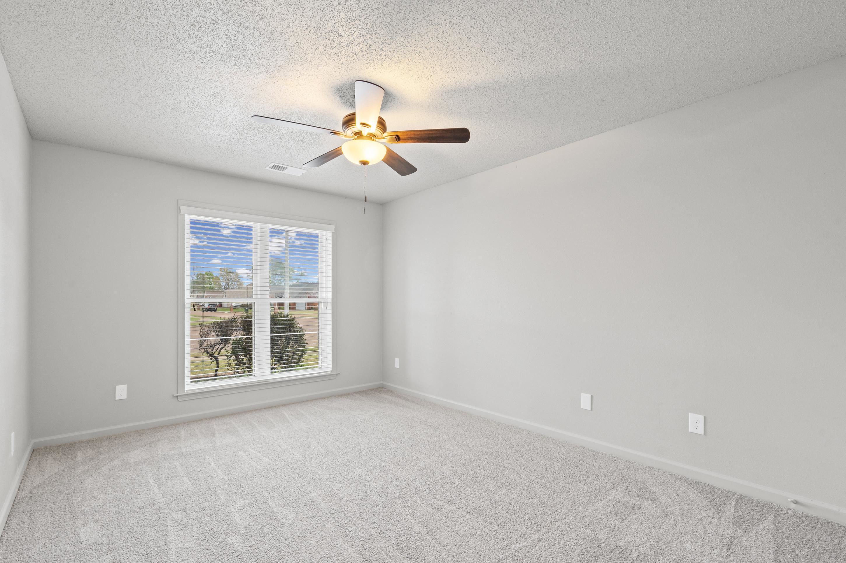 1301 Wolf Lair Drive Collierville, TN 38017 - Photo 18 of 32 Unfurnished bedroom with light colored carpet, a textured ceiling, and ceiling fan