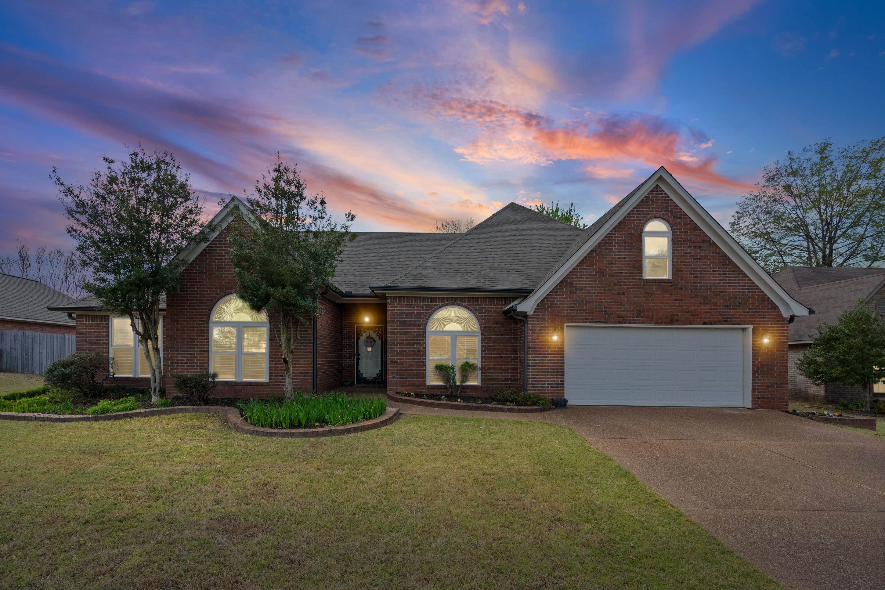 1301 Wolf Lair Drive Collierville, TN 38017 - Photo 2 of 32 Traditional-style house featuring a garage, brick siding, concrete driveway, and a front lawn