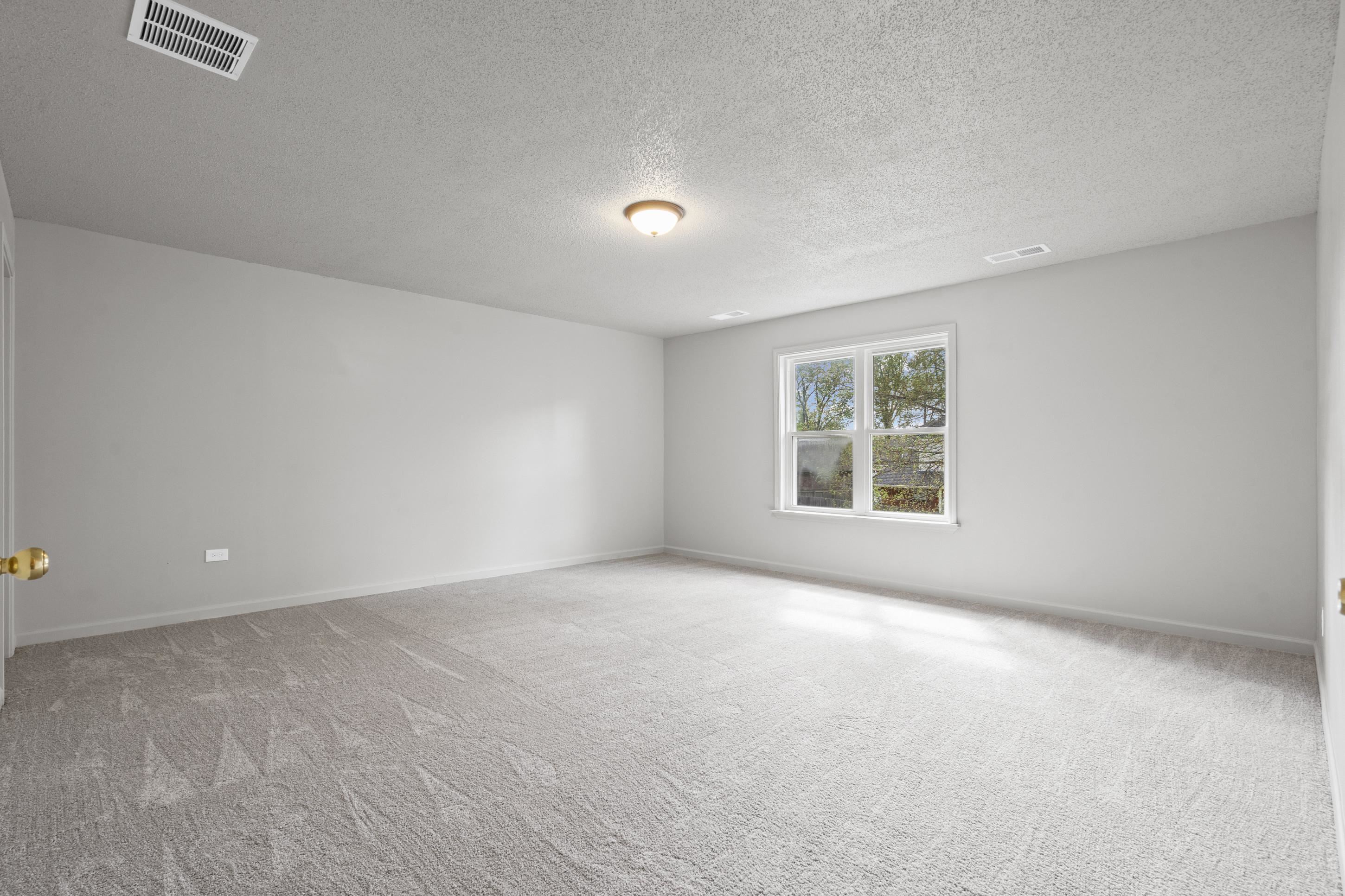 1301 Wolf Lair Drive Collierville, TN 38017 - Photo 23 of 32 Bedroom 4 or Bonus/Game room, upstairs, featuring new light colored carpet, freshly painted walls and a textured ceiling