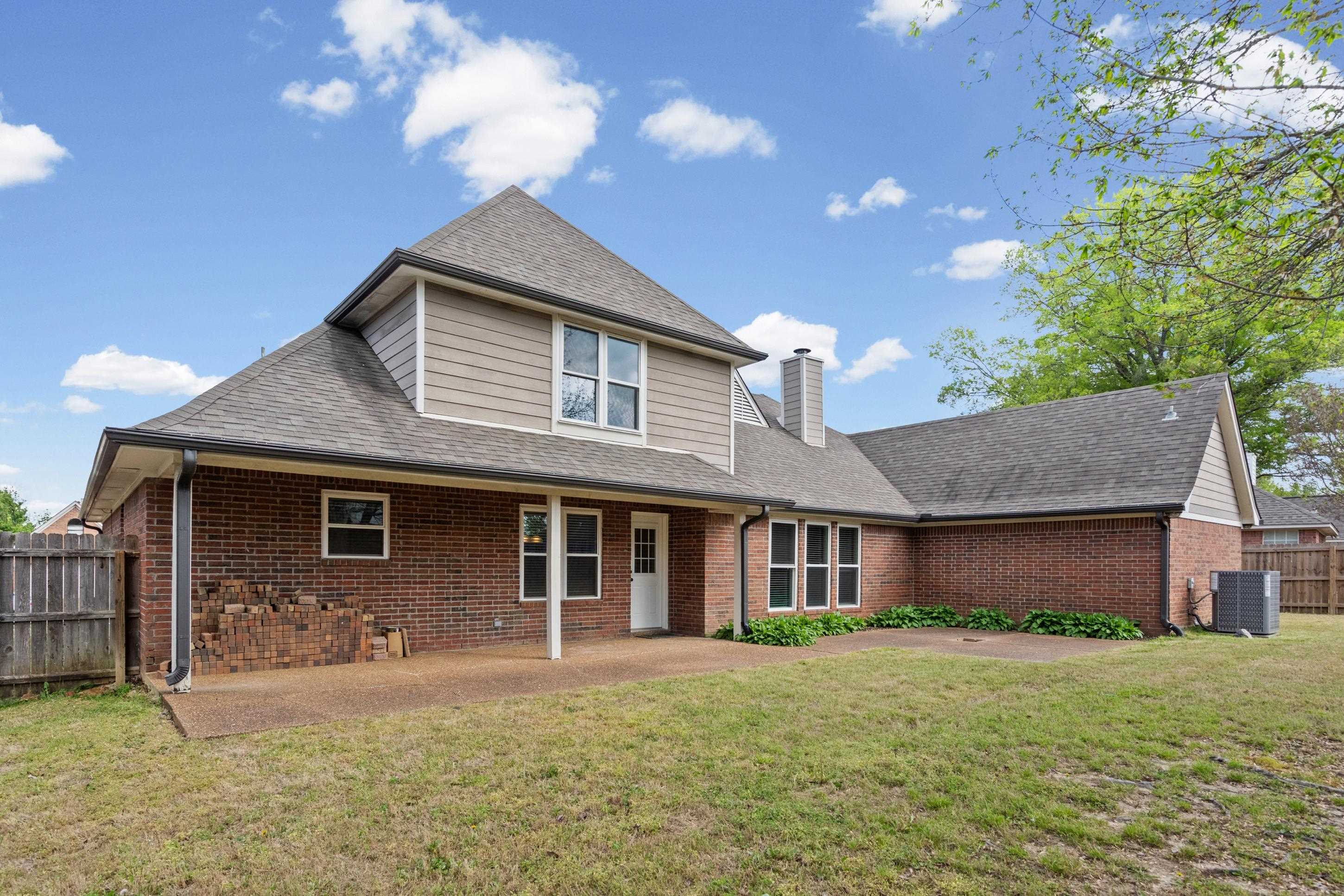 1301 Wolf Lair Drive Collierville, TN 38017 - Photo 26 of 32 Back of property featuring a fenced backyard, brick siding, and a patio