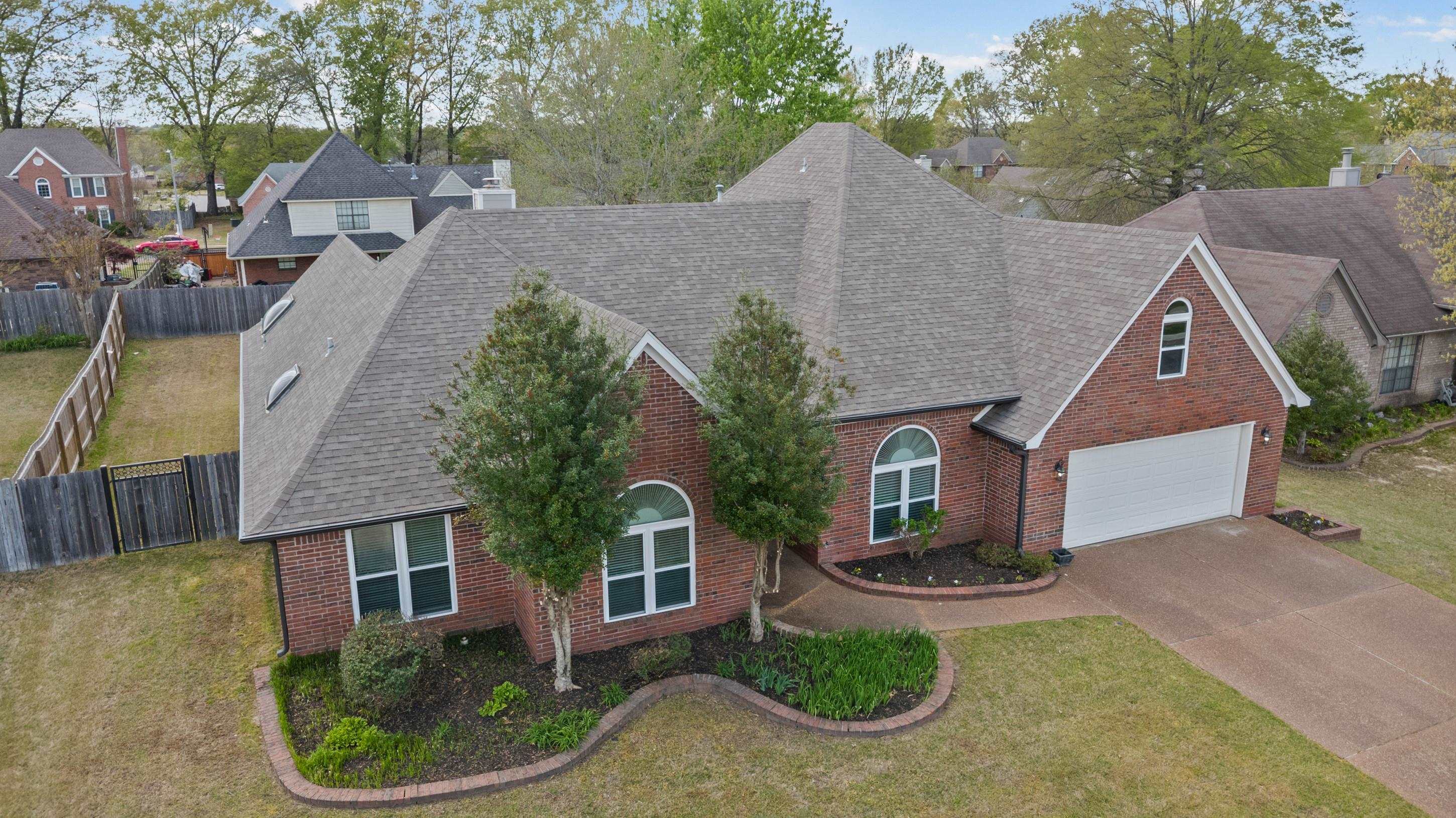 1301 Wolf Lair Drive Collierville, TN 38017 - Photo 30 of 32 View of front of house featuring brick siding, roof with shingles, driveway, and an attached garage