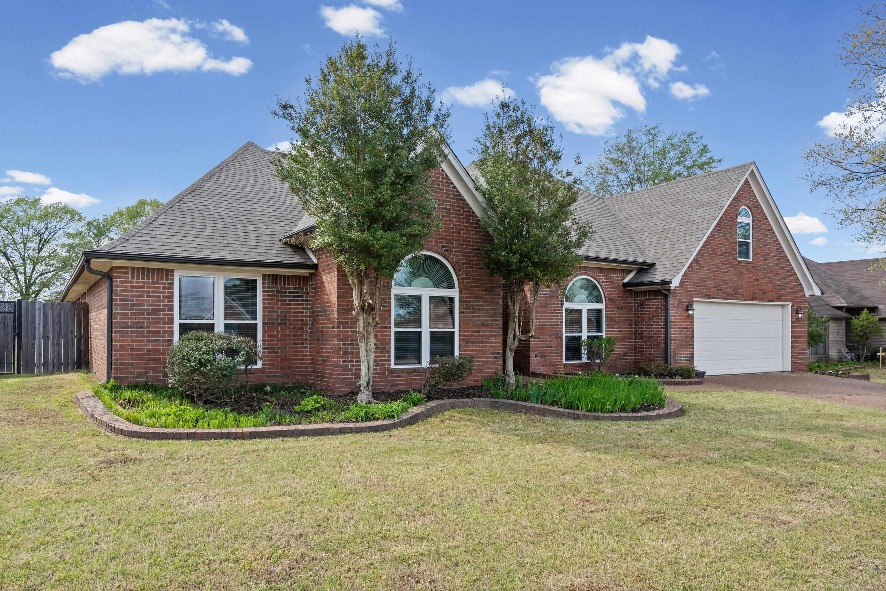 1301 Wolf Lair Drive Collierville, TN 38017 - Photo 3 of 32 View of front of home featuring roof with shingles, brick siding, driveway, and a garage
