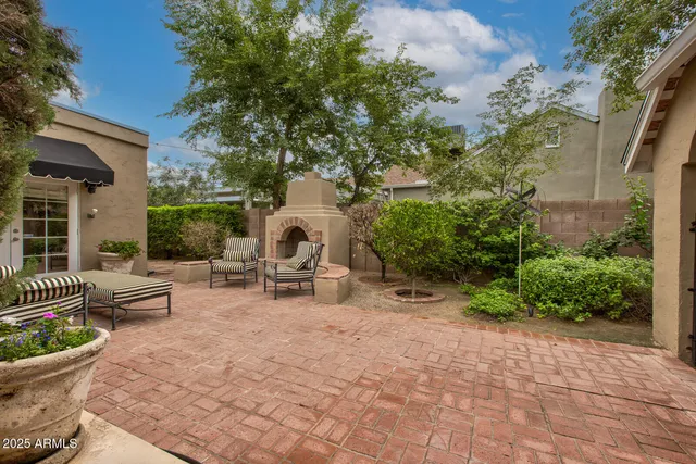 a view of a patio with a table and chairs and plants