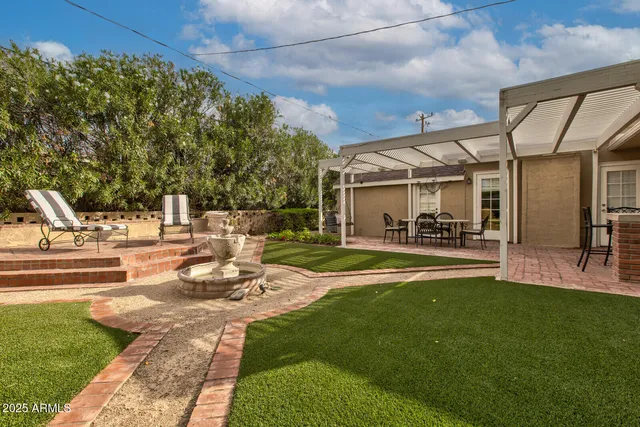 a view of a patio with couches chairs and a big yard