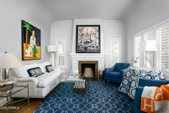 a living room with furniture fireplace and window