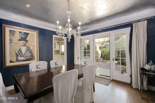 a view of a dining room with furniture wooden floor and chandelier