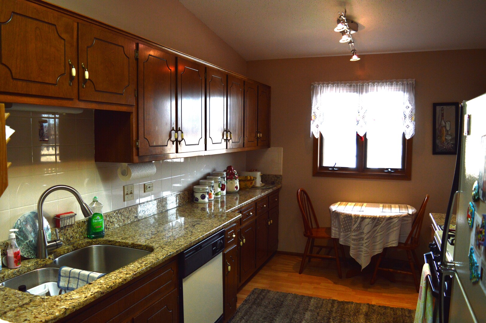 10636 Ridgeland Avenue, Unit 3C Chicago Ridge, IL 60415 - Photo 3 of 9 a kitchen with granite countertop stainless steel appliances a stove a sink and a large window