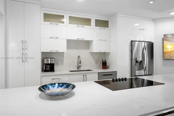 a kitchen with a refrigerator and a sink