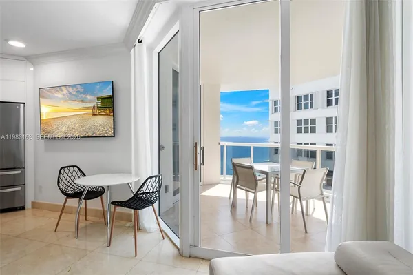 a view of a dining room with furniture and a potted plant