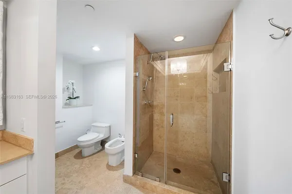 a bathroom with a shower a toilet and a sink