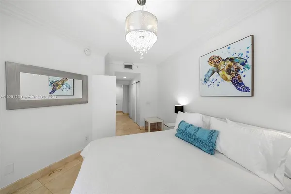 a bedroom with a bed and a painting on the wall