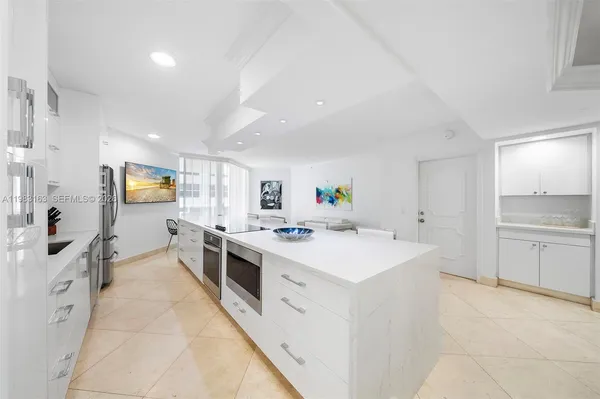 a large kitchen with a stove and cabinets