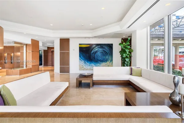 a living room with furniture and kitchen view