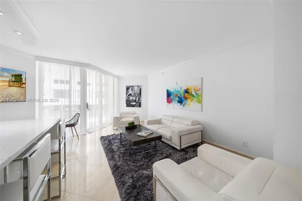 a living room with furniture and a painting on the wall