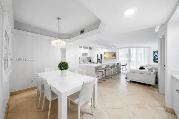 a view of a dining room with furniture and a chandelier
