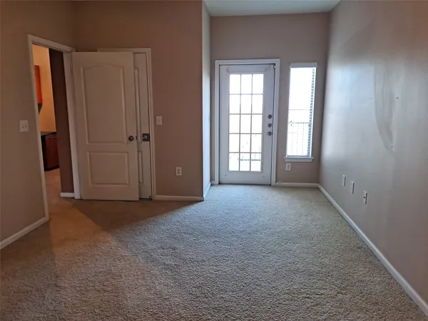 an empty room with windows and closet
