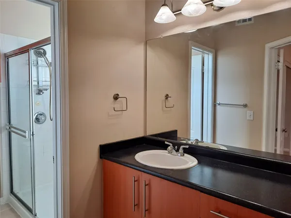 a en suite bathroom with a tub shower and a sink