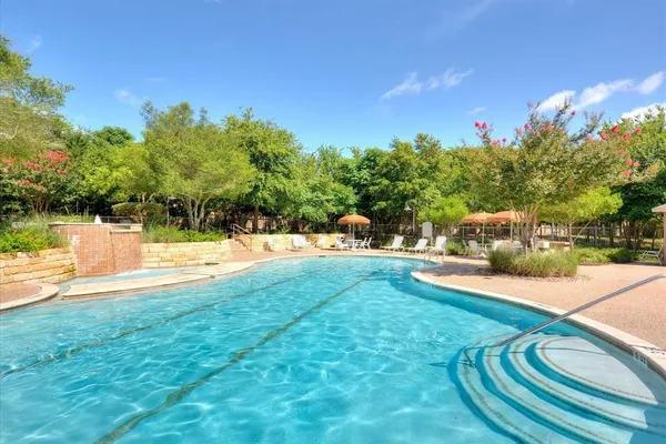a view of a house with swimming pool and sitting area