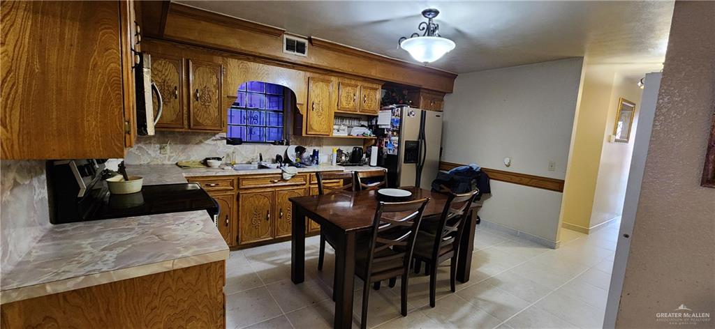 2824 Hawk Street Roma, TX 78584 - Photo 11 of 16 a kitchen with a table and chairs in it