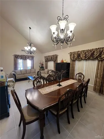 a view of a dining room with furniture and chandelier