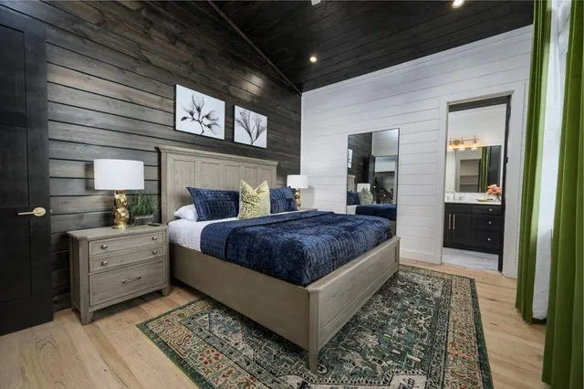 a bedroom with a large bed and a mirror