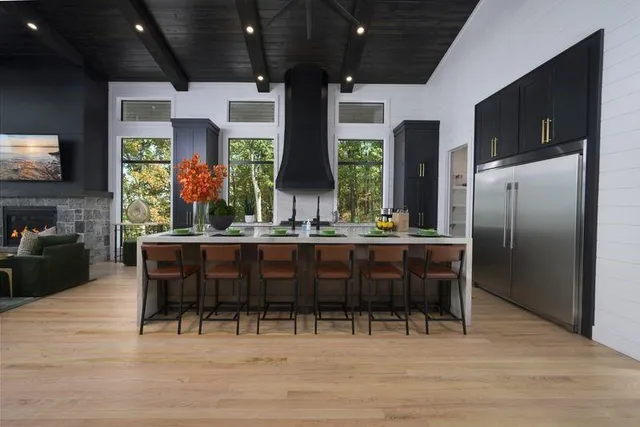 a dining room with furniture a flat screen tv and floor to ceiling window