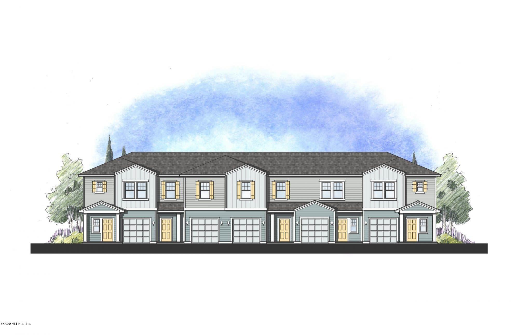 a front view of a residential apartment building with a yard