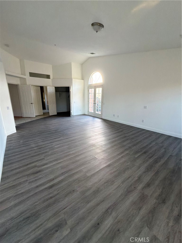 48628 Adeline Way Morongo Valley, CA 92256 - Photo 13 of 26 an empty room with wooden floor and fireplace