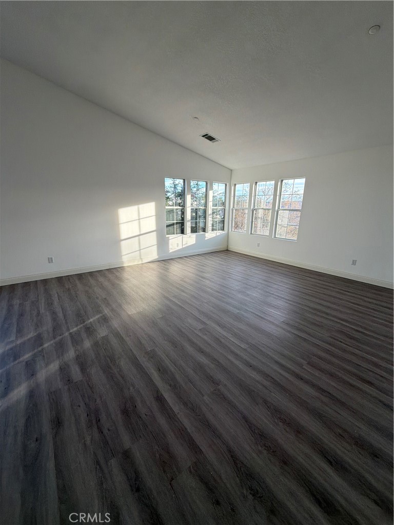 48628 Adeline Way Morongo Valley, CA 92256 - Photo 4 of 26 an empty room with wooden floor and windows
