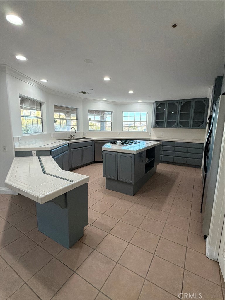 48628 Adeline Way Morongo Valley, CA 92256 - Photo 8 of 26 a large kitchen with kitchen island a sink a counter top and stainless steel appliances