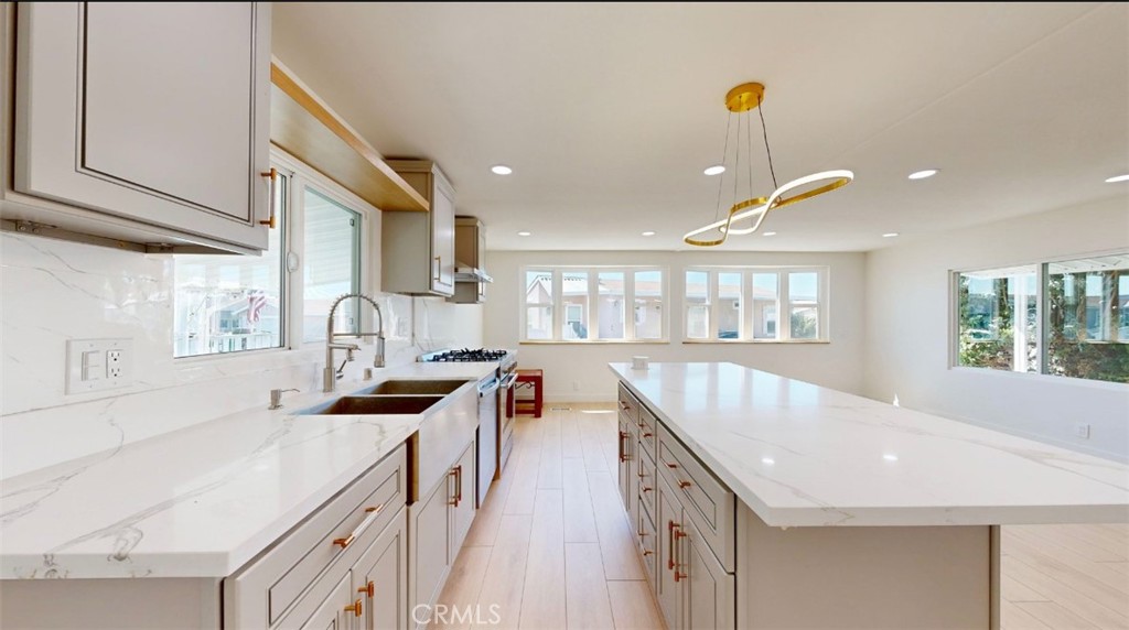 55 Walnut Via Anaheim, CA 92801 - Photo 3 of 25 a kitchen with stainless steel appliances a sink a stove and a wooden floors