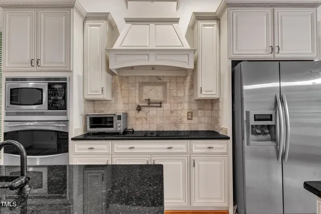 a kitchen with granite countertop a cabinets and steel stainless steel appliances
