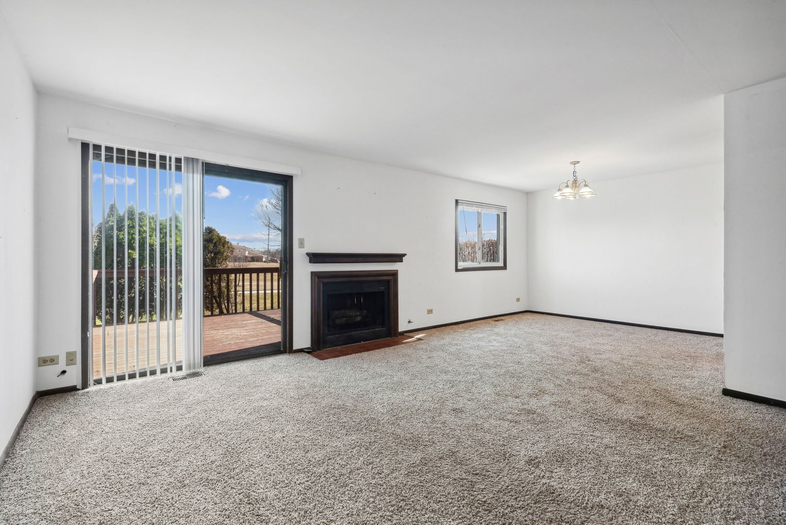 889 Heatherbrook Court Wheaton, IL 60189 - Photo 4 of 24 a view of an empty room with a fireplace and a window