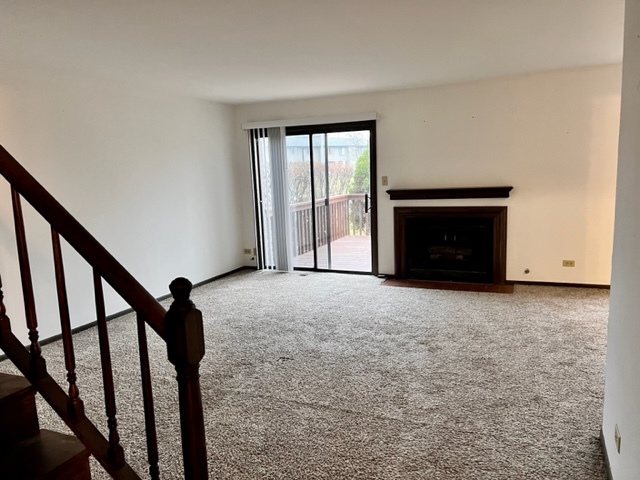 889 Heatherbrook Court Wheaton, IL 60189 - Photo 5 of 24 a view of an empty room with a fireplace and a window