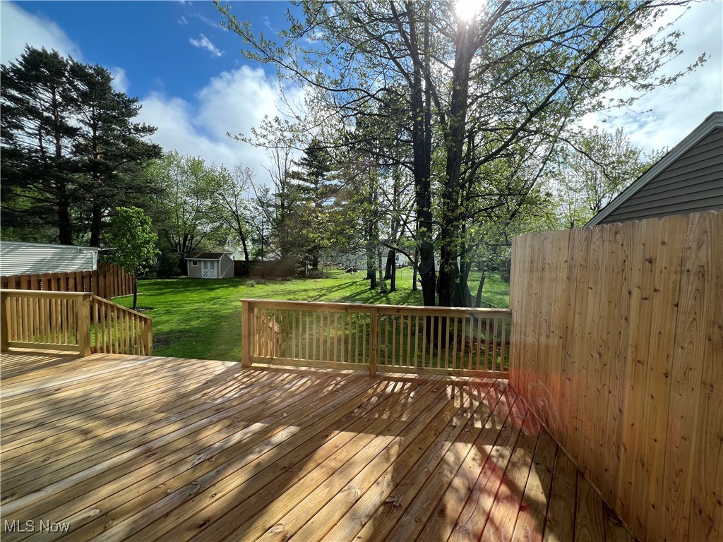 1279 Lander Road Cleveland, OH 44124 - Photo 6 of 37 Wooden terrace with an outbuilding, fence, a lawn, and a shed
