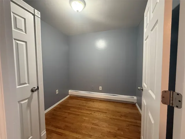a kitchen with a sink a refrigerator and wooden floor