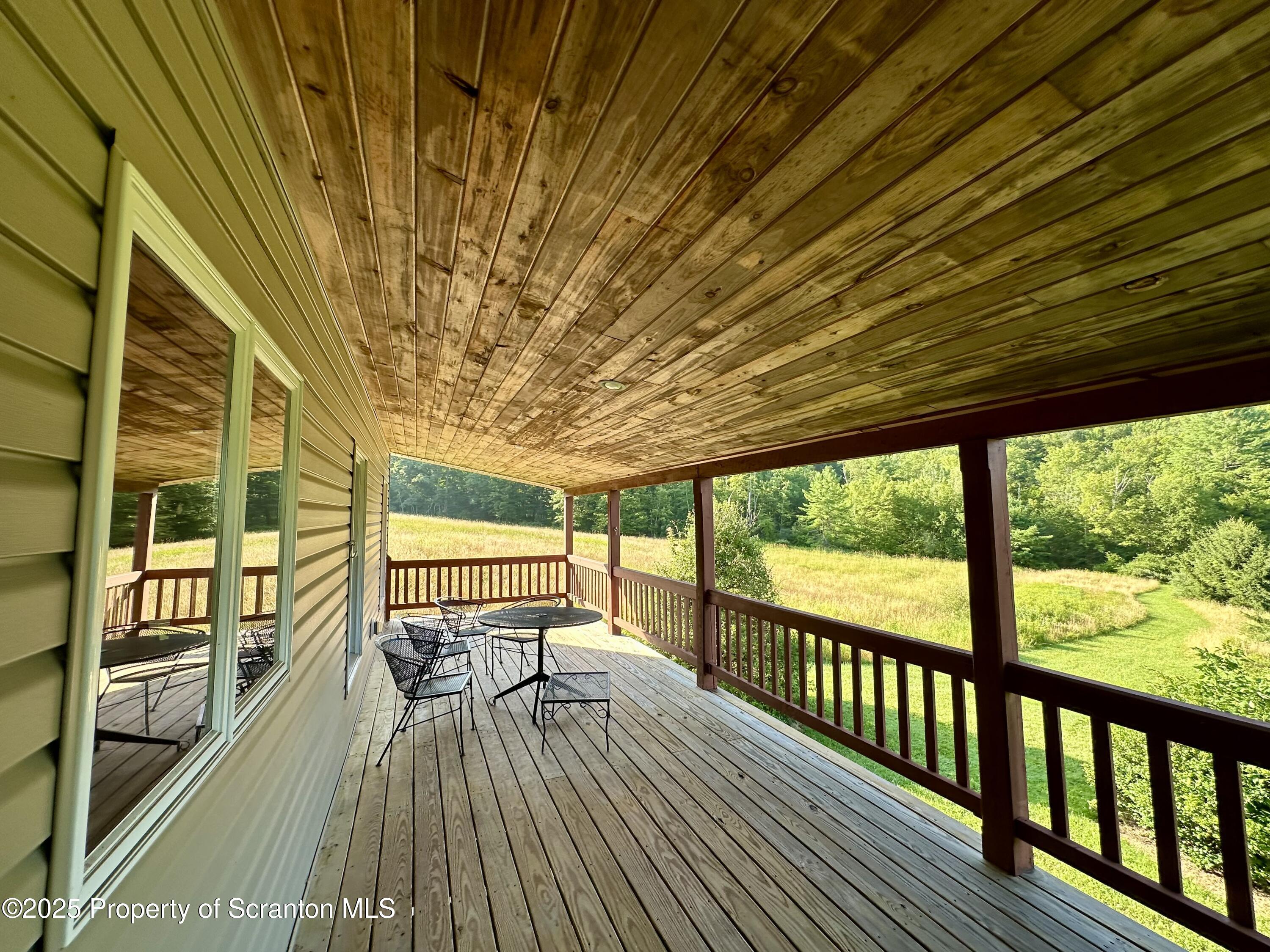 5290 Irish Hill Road Montrose, PA 18801 - Photo 39 of 67 a view of a balcony with wooden floor