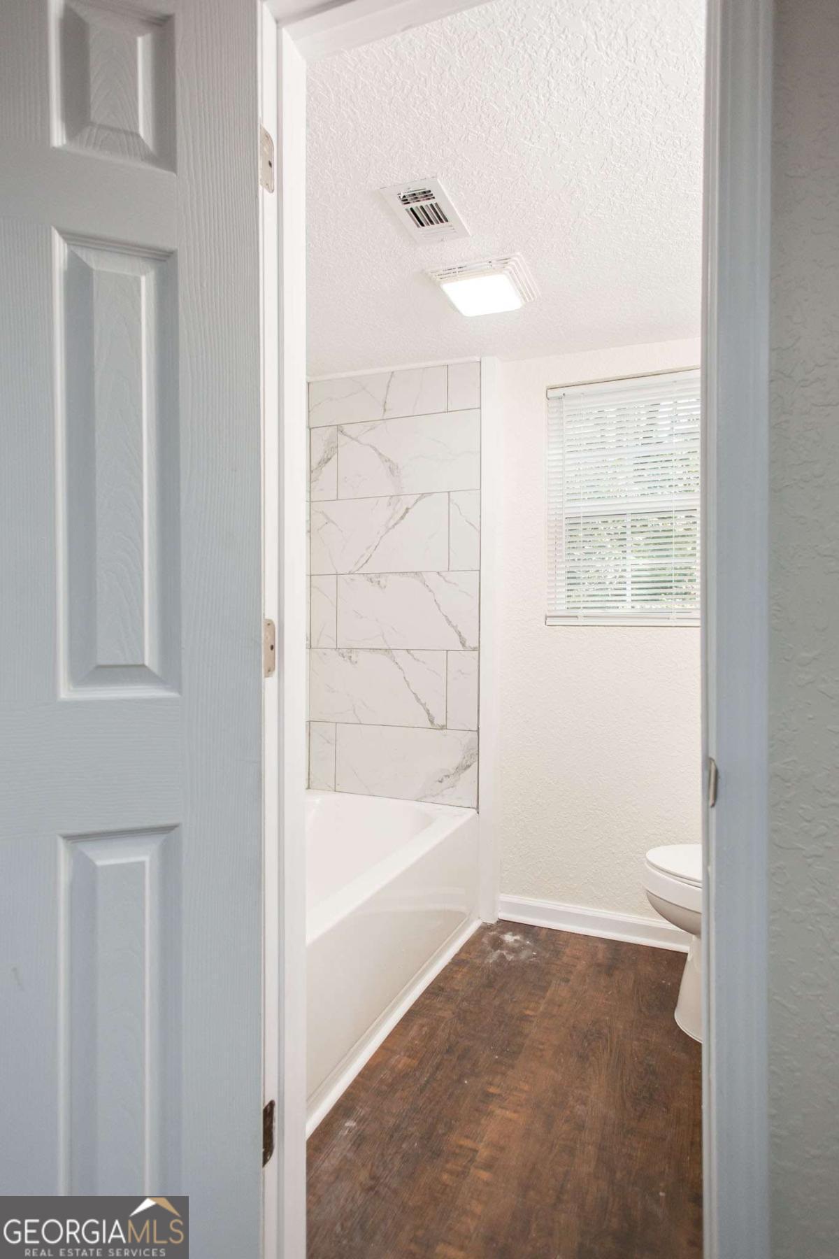 1410 Hazel Street Waycross, GA 31501 - Photo 11 of 21 a bathroom with bathtub and a shower