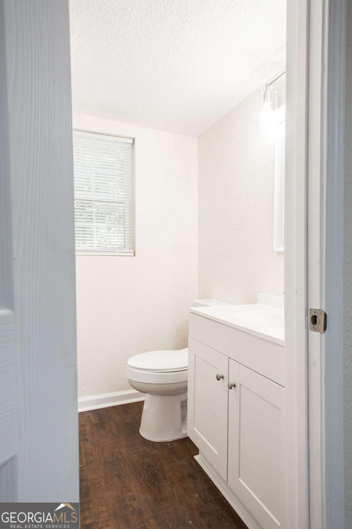 1410 Hazel Street Waycross, GA 31501 - Photo 12 of 21 a white toilet sitting next to a bathroom sink