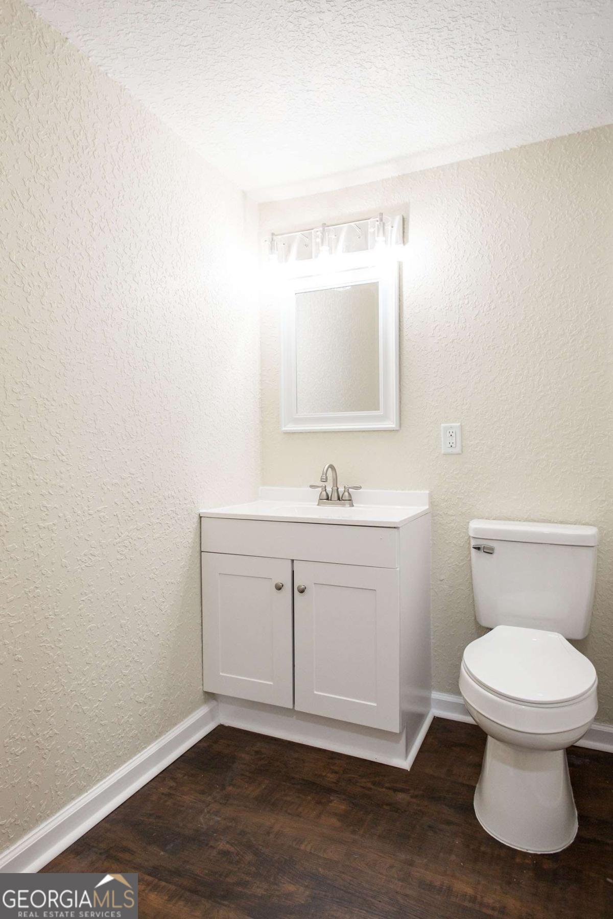 1410 Hazel Street Waycross, GA 31501 - Photo 14 of 21 a bathroom with a toilet sink and mirror