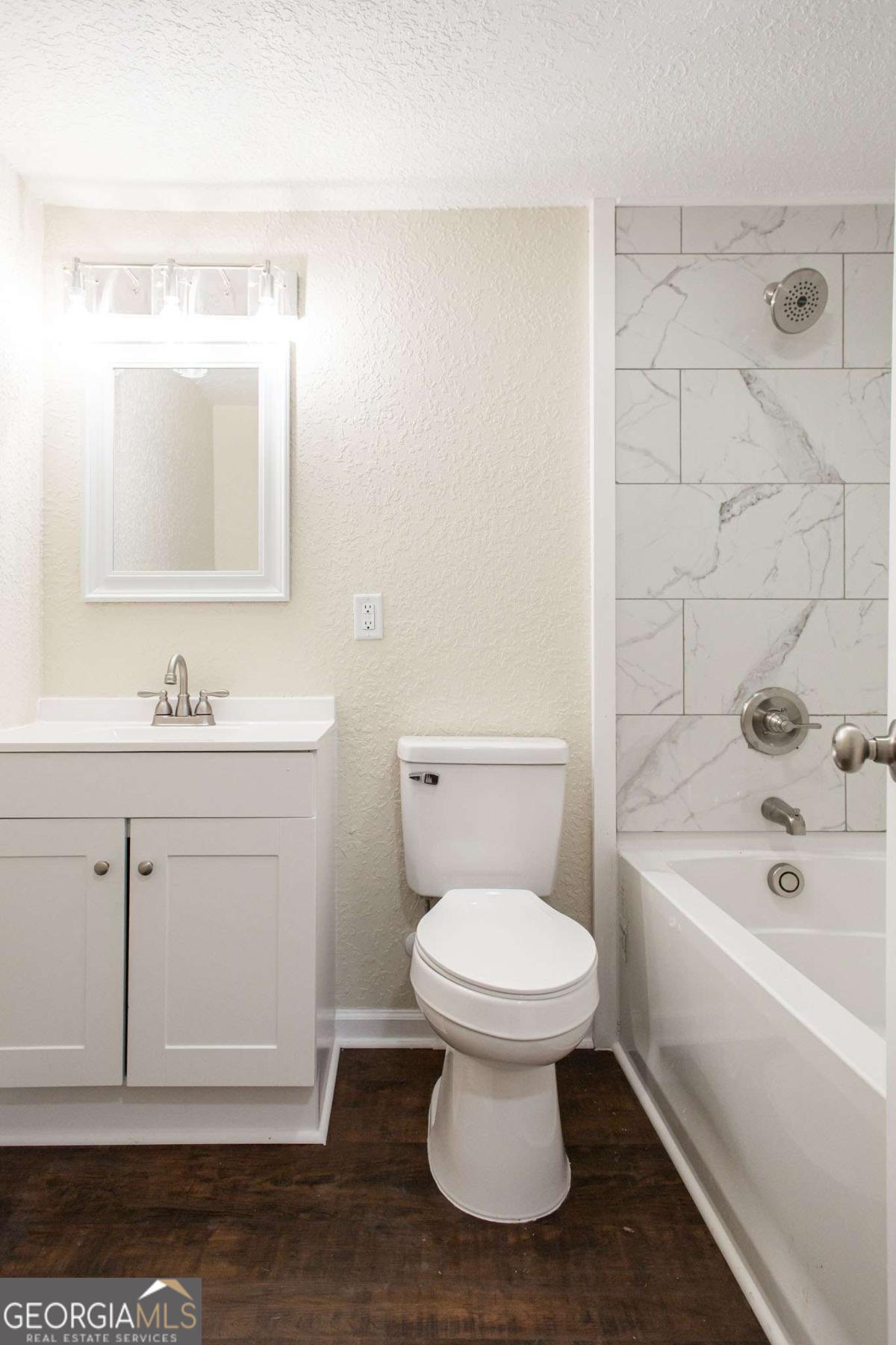 1410 Hazel Street Waycross, GA 31501 - Photo 15 of 21 a bathroom with a sink toilet a shower and bathtub
