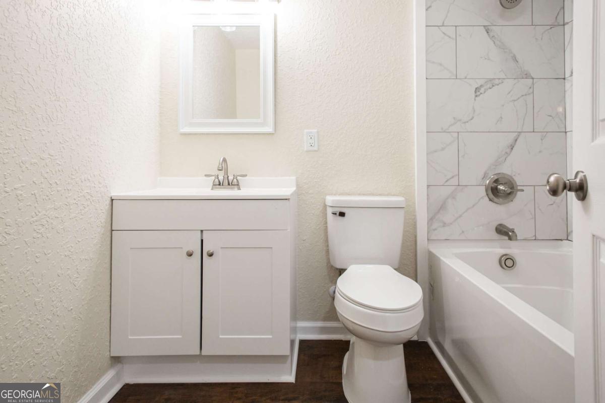 1410 Hazel Street Waycross, GA 31501 - Photo 16 of 21 a bathroom with a sink a toilet and shower