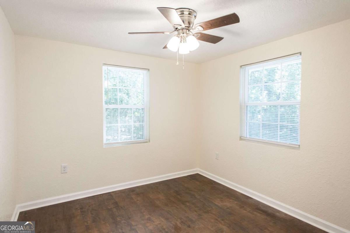 1410 Hazel Street Waycross, GA 31501 - Photo 19 of 21 an empty room with a window and a fan