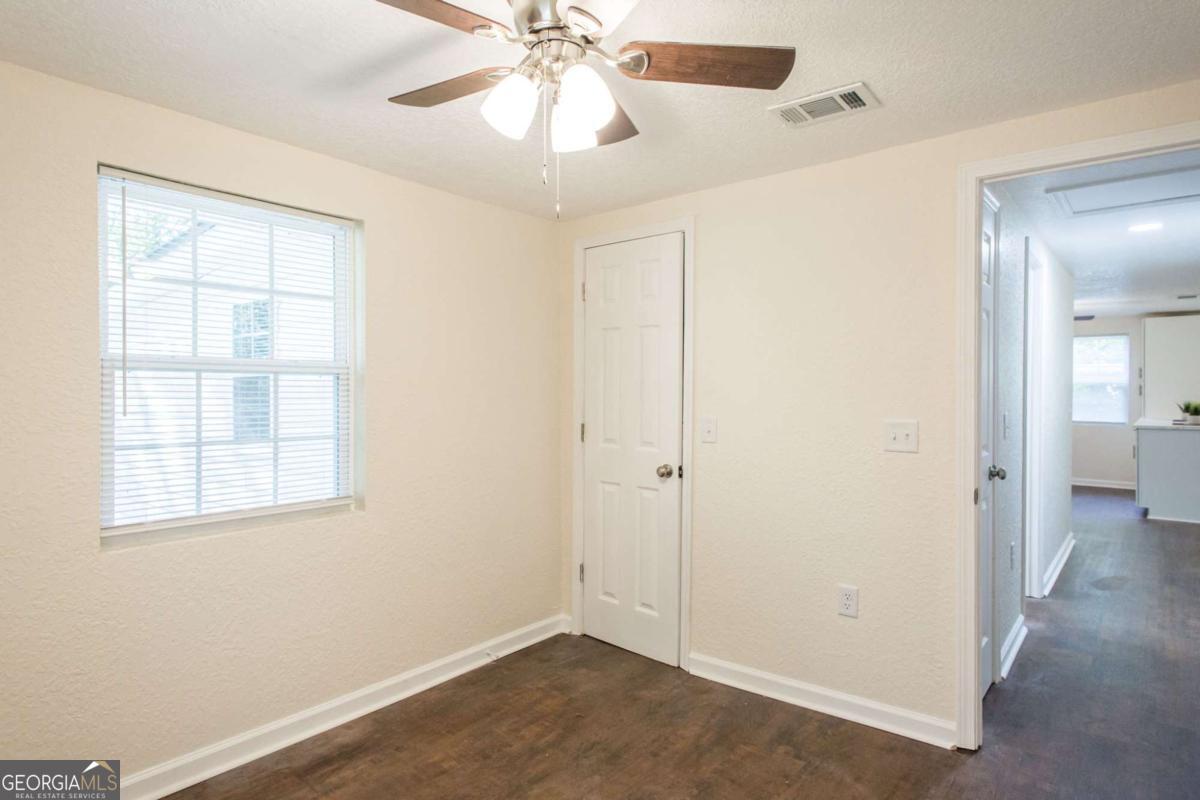 1410 Hazel Street Waycross, GA 31501 - Photo 20 of 21 an empty room with windows and fan